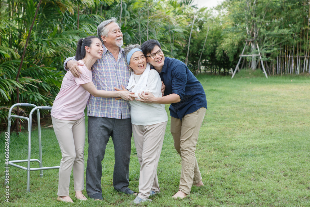 asian senior father trying walk with walker and adult son daughter wife support in gaden at home. old man disabled walking and caregiver young man helping in back yard . health care family lifestyle asian senior father trying walk with walker and adult son daughter wife support in gaden at home. old man disabled walking and caregiver young man helping in back yard . health care family lifestyle