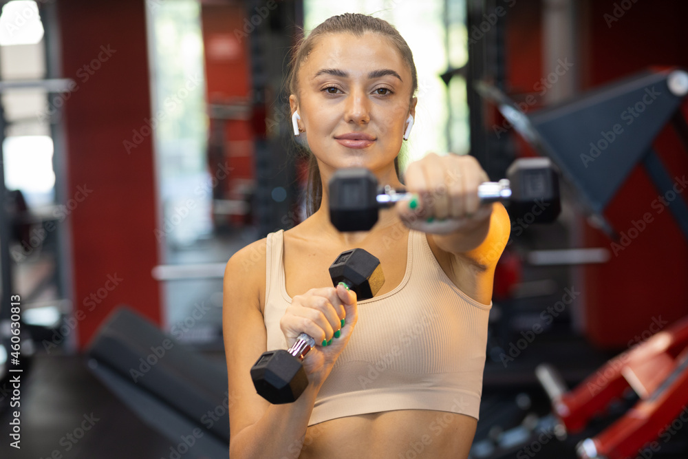 Fototapeta premium Fitness woman exercising with dumbbells