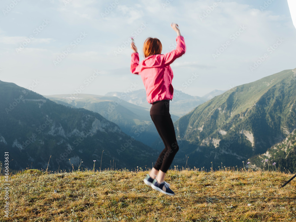 cheerful woman in the mountains nature outdoor activities jump cheerful woman in the mountains nature outdoor activities jump