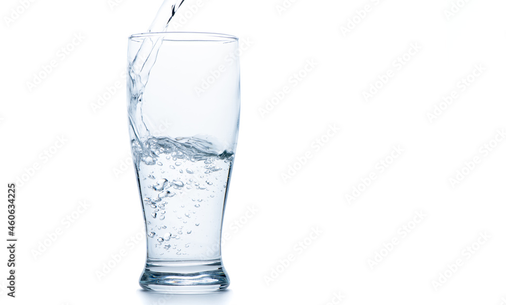 Water pouring into the clear Pilsner glass isolated on white Water pouring into the clear Pilsner glass isolated on white
