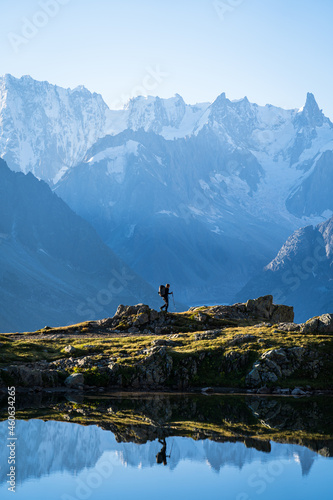 Woman hiking at Lac des Cheserys, with a view at the beautufil mountaoins of Chamonix.