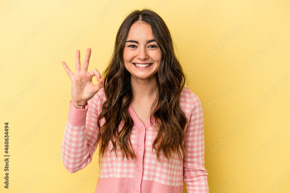 Young caucasian woman isolated on yellow background cheerful and confident showing ok gesture. Young caucasian woman isolated on yellow background cheerful and confident showing ok gesture.