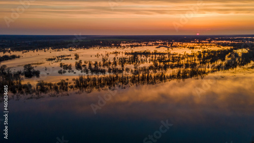 Aerial atmospheric view on big river. Aerial drone view of river landscape in sunny sunset. Nature concept.