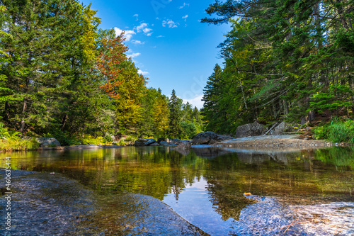 The clear waters of the Ammonoosuk River amid woods and smooth granite slabs off Mount Washington in the White Mountain National Forest in New Hampshire.