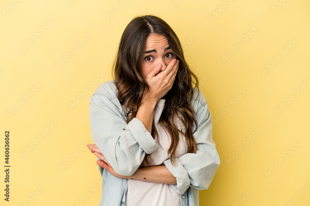 Young caucasian woman isolated on yellow background scared and afraid. Young caucasian woman isolated on yellow background scared and afraid.