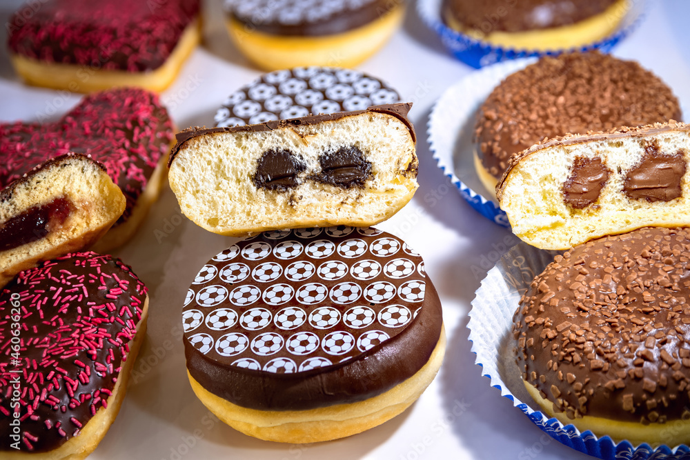 Assorted doughnuts with jelly filling. Cream Filled Donuts on table. Assorted doughnuts with jelly filling. Cream Filled Donuts on table.