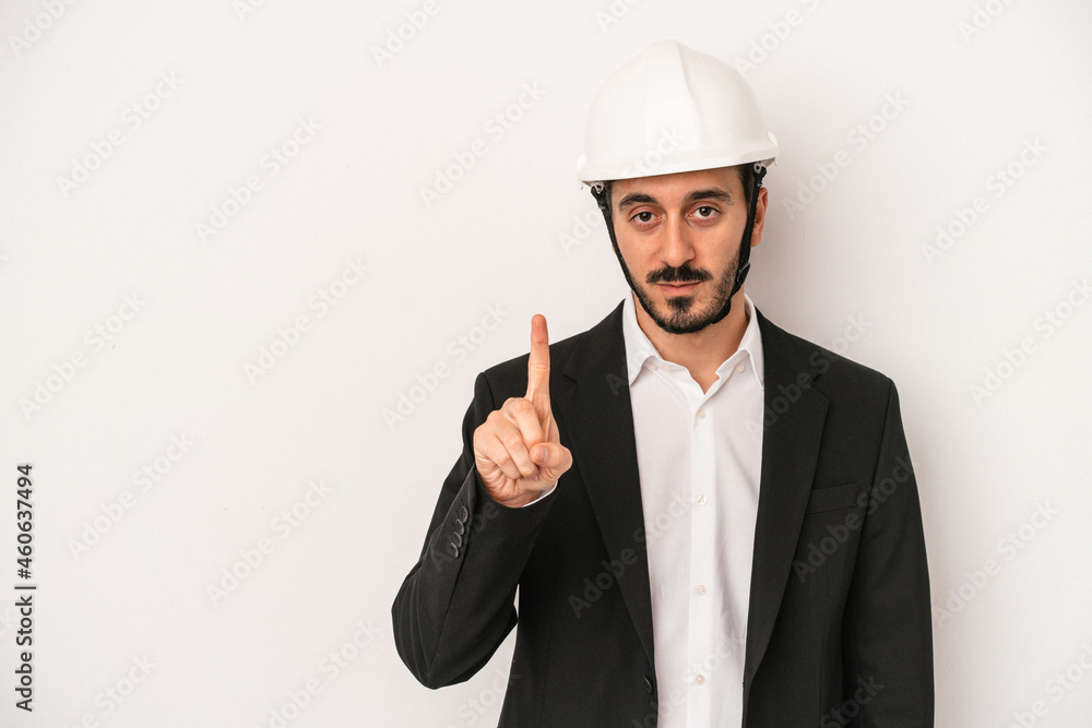 Young architect man wearing a construction helmet isolated on white background showing number one with finger. Young architect man wearing a construction helmet isolated on white background showing number one with finger.