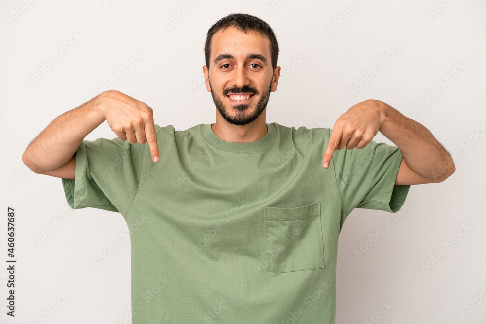 Young caucasian man isolated on white background points down with fingers, positive feeling. Young caucasian man isolated on white background points down with fingers, positive feeling.
