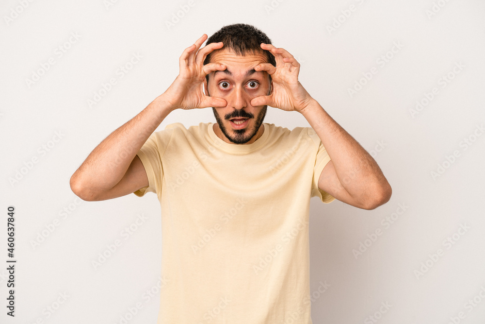 Young caucasian man isolated on white background keeping eyes opened to find a success opportunity. Young caucasian man isolated on white background keeping eyes opened to find a success opportunity.