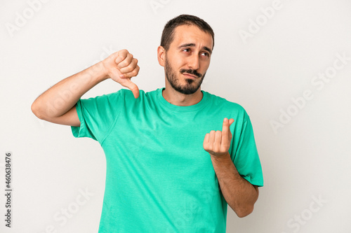 Young caucasian man isolated on white background showing that she has no money.