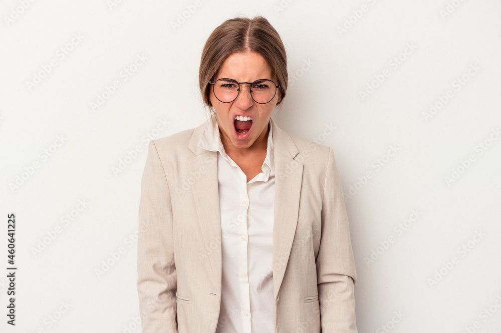 Young Russian business woman isolated on white background screaming very angry and aggressive.