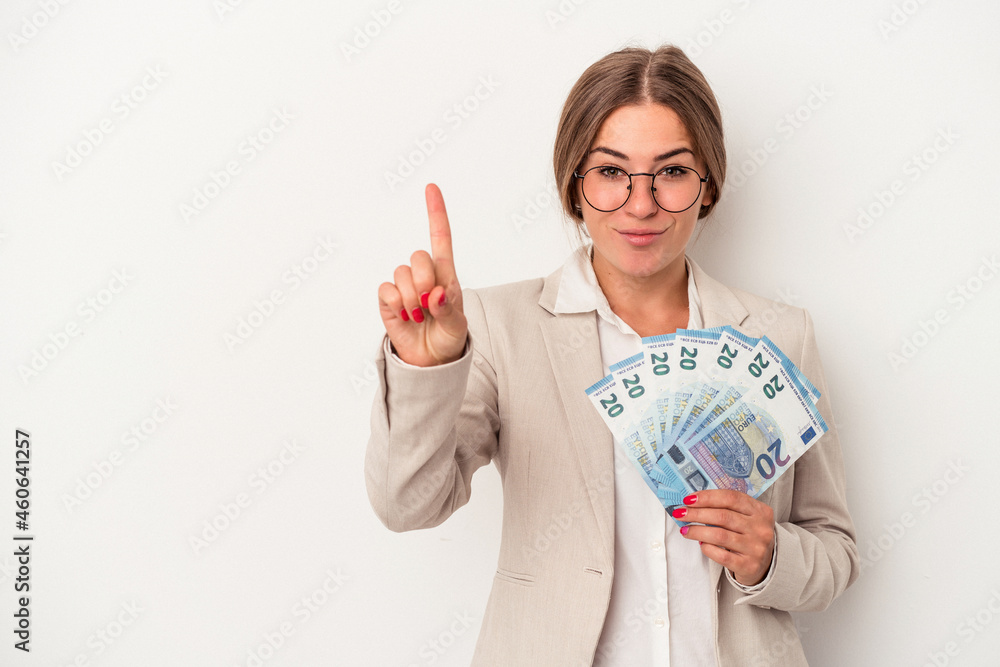 Young Russian business woman holding banknotes isolated on white background showing number one with finger. Young Russian business woman holding banknotes isolated on white background showing number one with finger.