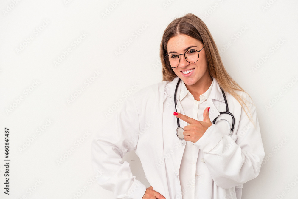 Fototapeta premium Young doctor Russian woman isolated on white background smiling and pointing aside, showing something at blank space.