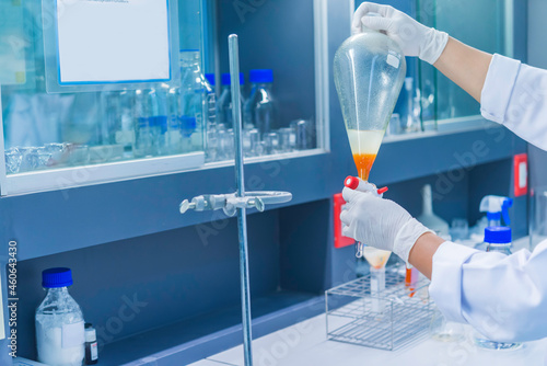 Scientist mix chemicals with The shake machine Before the experiment.Mixture laced with samples into test tubes,Thailand scientist working in the lab