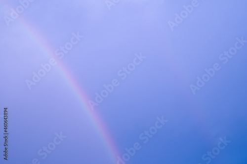 curve multi color double rainbow on blue sky. abstract pastel light on hogh air on climate after rain fallen.