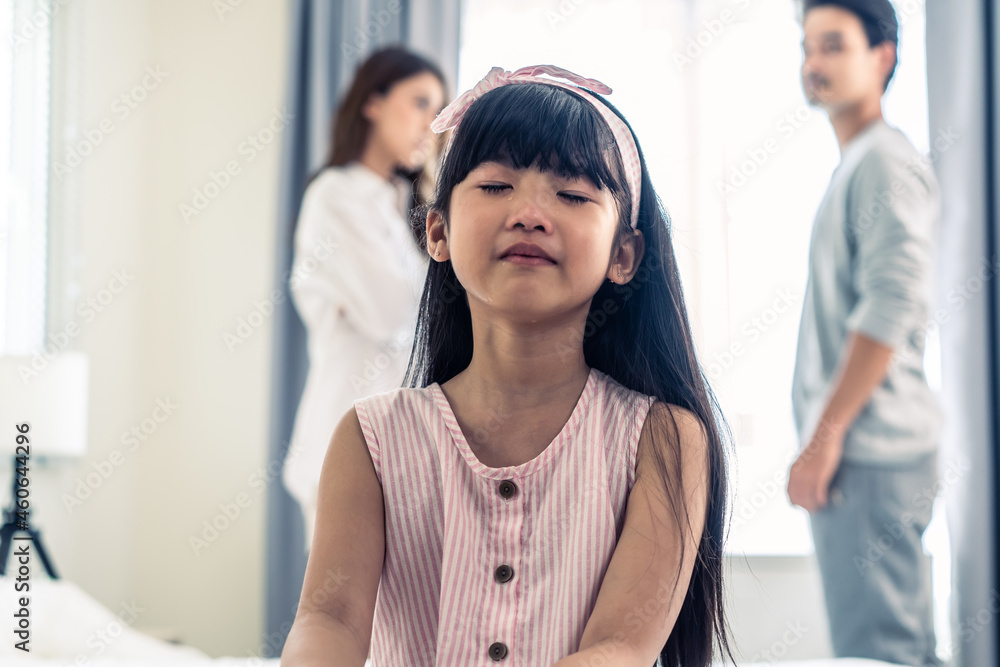 Asian little girl crying while parents fighting or quarrel conflict. Asian little girl crying while parents fighting or quarrel conflict.
