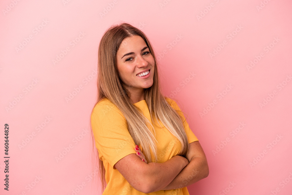 Young Russian woman isolated on pink background showing victory sign and smiling broadly. Young Russian woman isolated on pink background showing victory sign and smiling broadly.