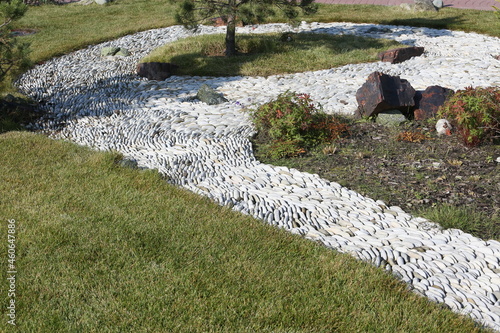 Little Japan in Kurkino district, Moscow city, Russia. Japanese garden. Japanese autumn park in Moscow with stones and plants. Architecture in asian, japanese style. Stone road in Japanese garden photo