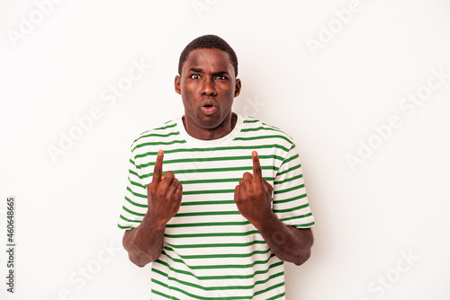 Young African American man isolated on white background pointing upside with opened mouth.