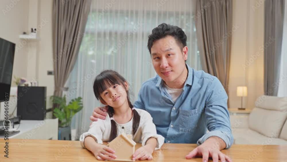Asian Father teach and motivate young daughter save money for future. Asian Father teach and motivate young daughter save money for future.