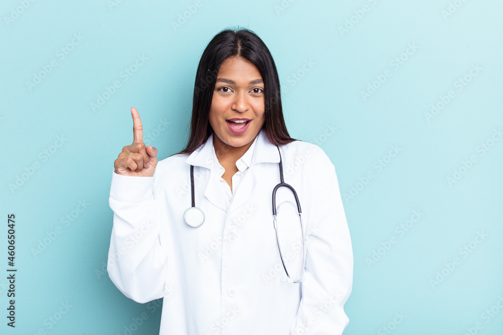 Young doctor Venezuelan woman isolated on blue background having an idea, inspiration concept. Young doctor Venezuelan woman isolated on blue background having an idea, inspiration concept.