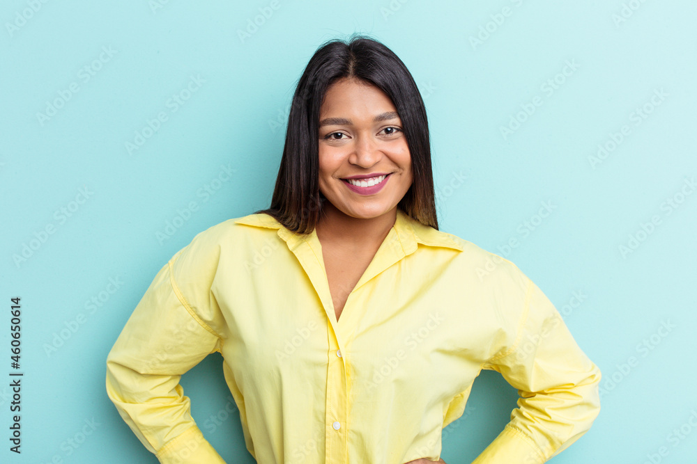 Young Venezuelan woman isolated on blue background confident keeping hands on hips. Young Venezuelan woman isolated on blue background confident keeping hands on hips.