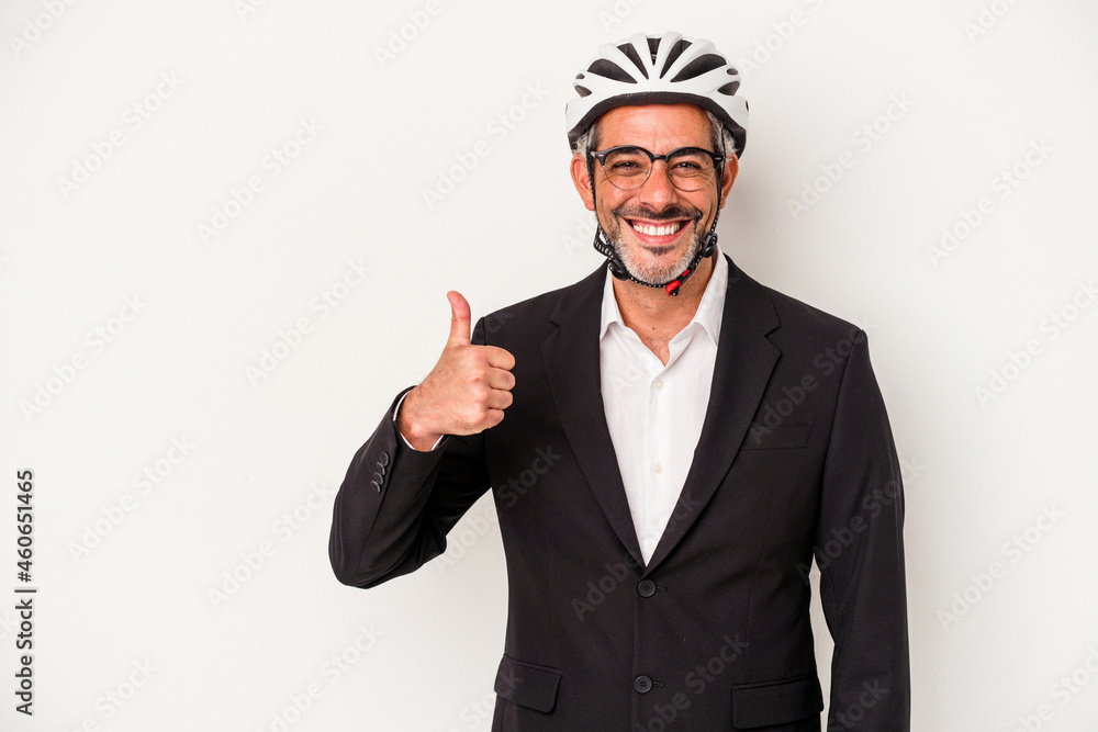 Middle age business man wearing a bike helmet isolated on blue background smiling and raising thumb up Middle age business man wearing a bike helmet isolated on blue background smiling and raising thumb up
