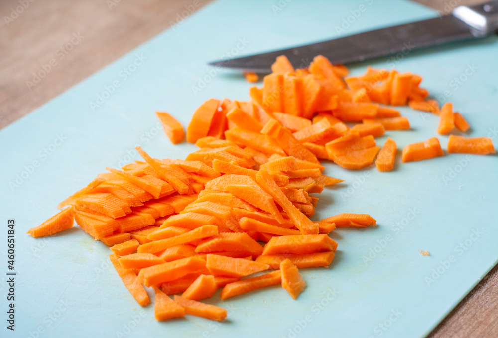 Chopped carrots on a plank. Cutting carrots into strips Chopped carrots on a plank. Cutting carrots into strips