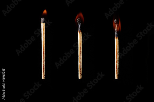 The stages of burning of wooden match on a black background