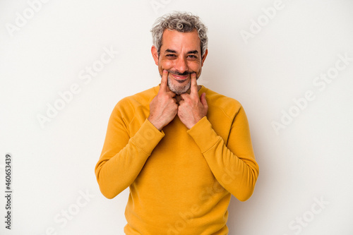 Middle age caucasian man isolated on white background doubting between two options.