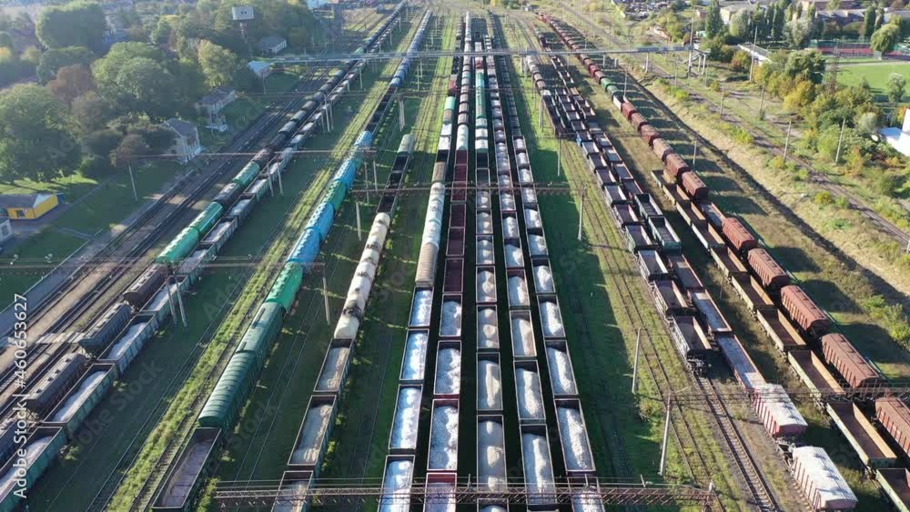 Cargo trains close-up. Aerial view of colorful freight trains on the railway station. Wagons with goods on railroad. Heavy industry. Industrial conceptual scene with trains. Top view from flying drone Cargo trains close-up. Aerial view of colorful freight trains on the railway station. Wagons with goods on railroad. Heavy industry. Industrial conceptual scene with trains. Top view from flying drone