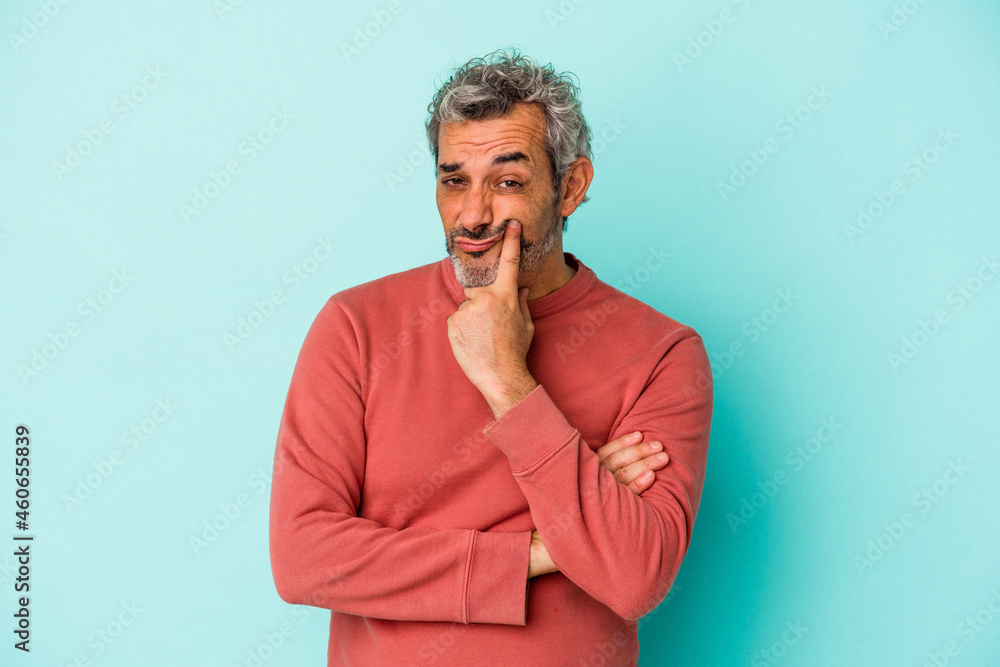 Middle age caucasian man isolated on blue background unhappy looking in camera with sarcastic expression. Middle age caucasian man isolated on blue background unhappy looking in camera with sarcastic expression.