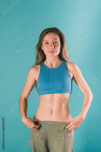 Portrait of young slim fitness woman. Sport and healthy lifestyle concept. © satura_