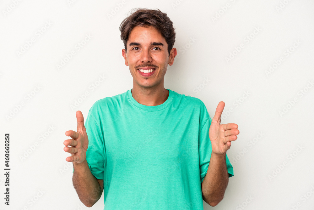 Young mixed race man isolated on white background holding something with both hands, product presentation. Young mixed race man isolated on white background holding something with both hands, product presentation.