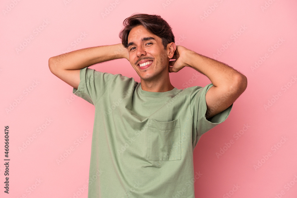 Young mixed race man isolated on white background stretching arms, relaxed position. Young mixed race man isolated on white background stretching arms, relaxed position.