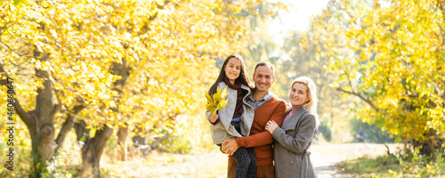 Family playing in autumn park having fun