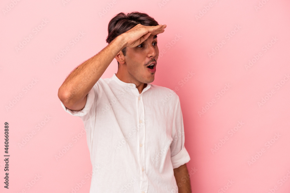 Young mixed race man isolated on white background looking far away keeping hand on forehead. Young mixed race man isolated on white background looking far away keeping hand on forehead.