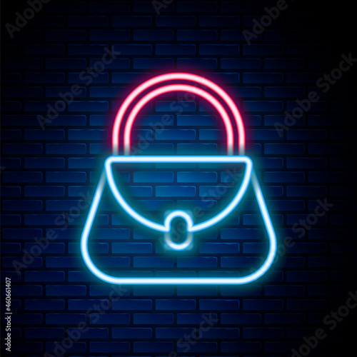 Glowing neon line Handbag icon isolated on brick wall background. Female handbag sign. Glamour casual baggage symbol. Colorful outline concept. Vector