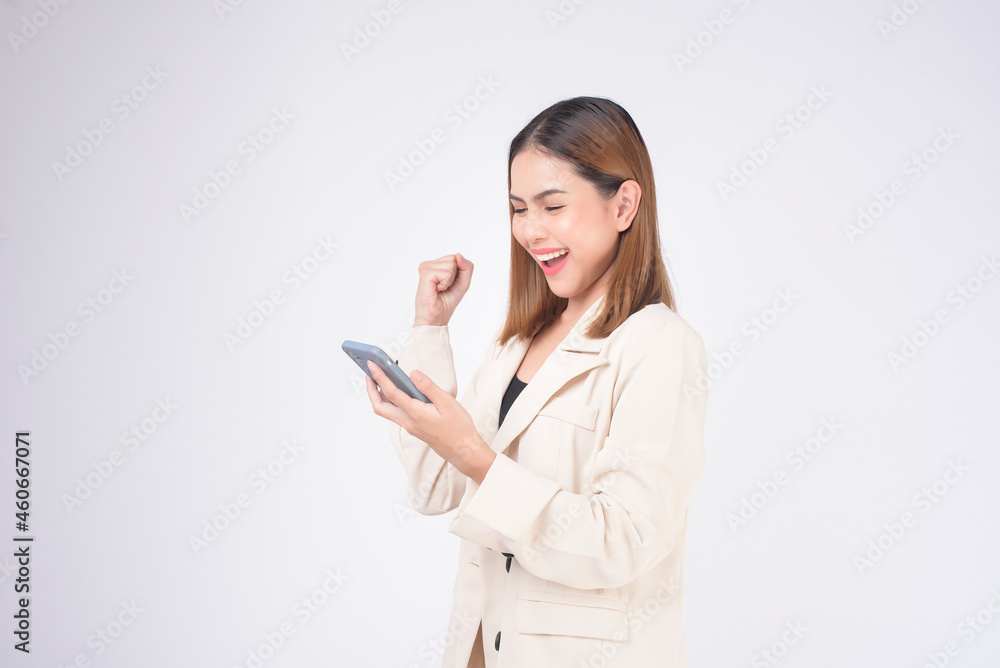 Portrait of young beautiful woman in suit using smart phone over white background. Portrait of young beautiful woman in suit using smart phone over white background.
