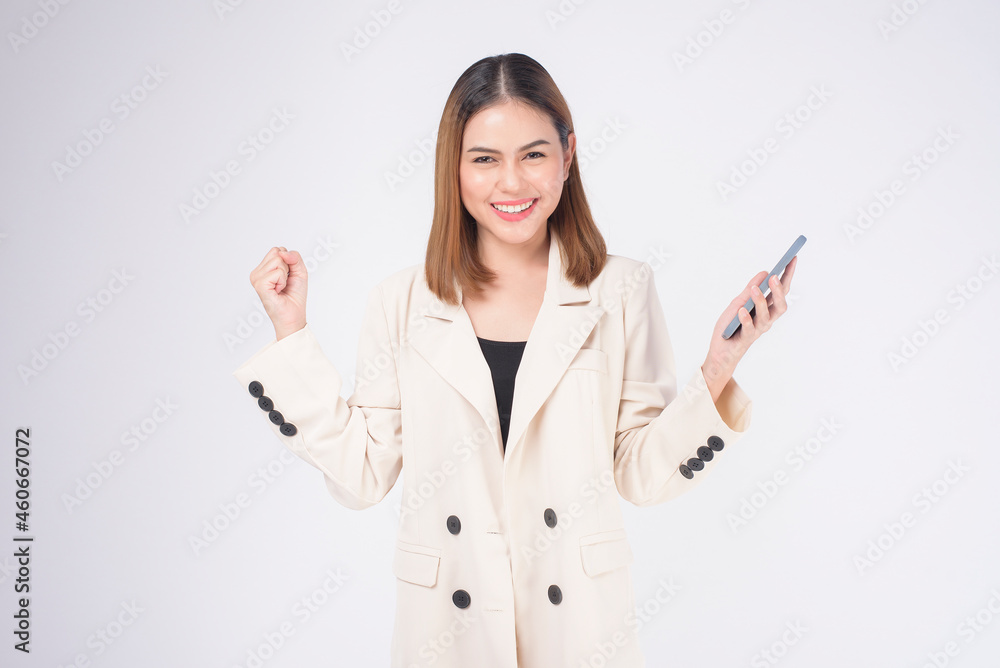 Portrait of young beautiful woman in suit using smart phone over white background. Portrait of young beautiful woman in suit using smart phone over white background.