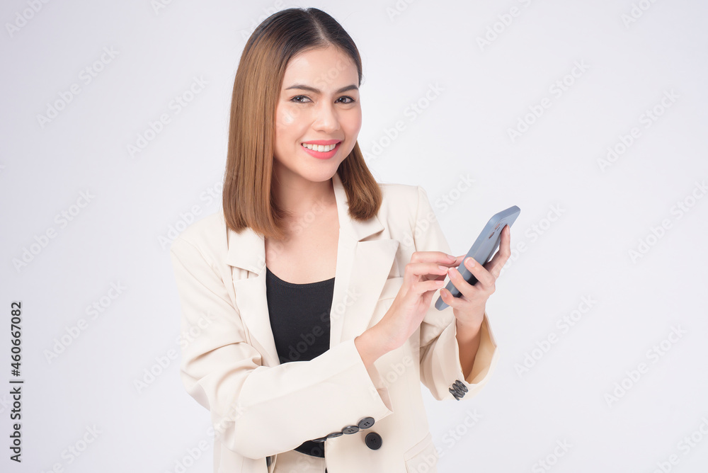 Portrait of young beautiful woman in suit using smart phone over white background. Portrait of young beautiful woman in suit using smart phone over white background.