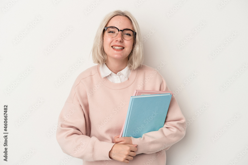 Young caucasian student woman holding books isolated on white background laughing and having fun. Young caucasian student woman holding books isolated on white background laughing and having fun.