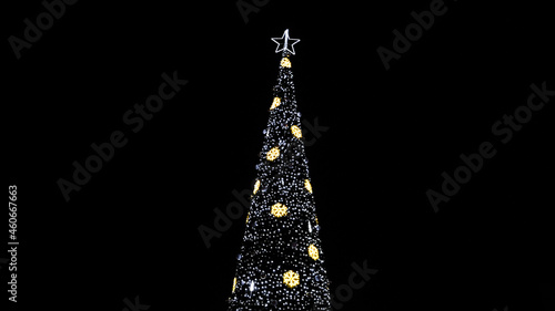 Huge christmas tree with lights at night background
