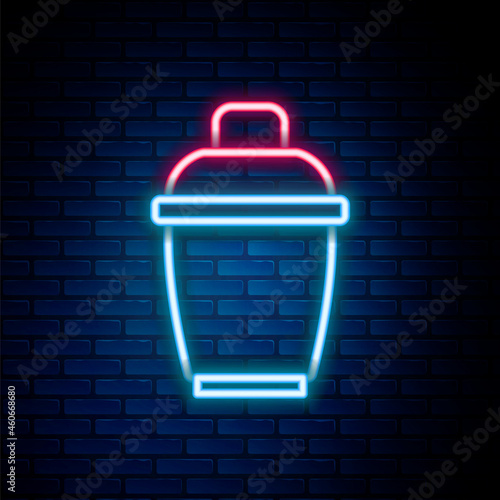 Glowing neon line Cocktail shaker icon isolated on brick wall background. Colorful outline concept. Vector