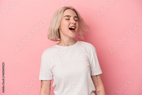 Young caucasian woman isolated on pink background dancing and having fun.
