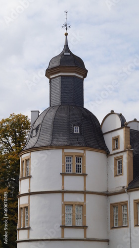 a castle shines outside and in the pond in autumn
