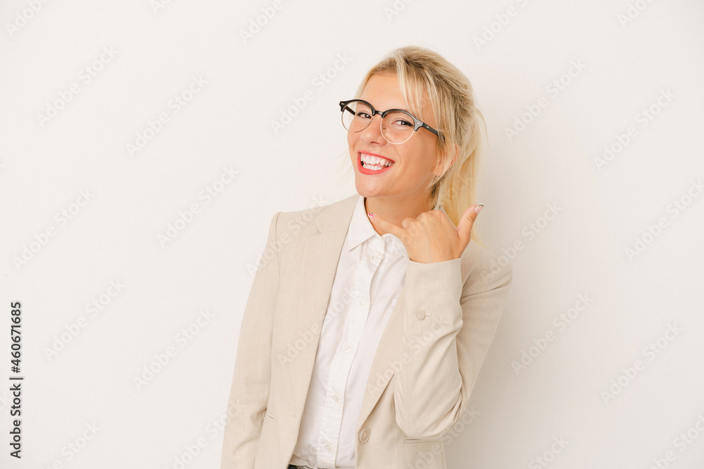 Young business Russian woman isolated on white background showing a mobile phone call gesture with fingers. Young business Russian woman isolated on white background showing a mobile phone call gesture with fingers.
