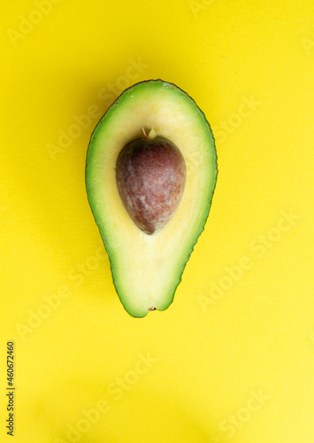 Cut avocado on a yellow background. Selective focus.