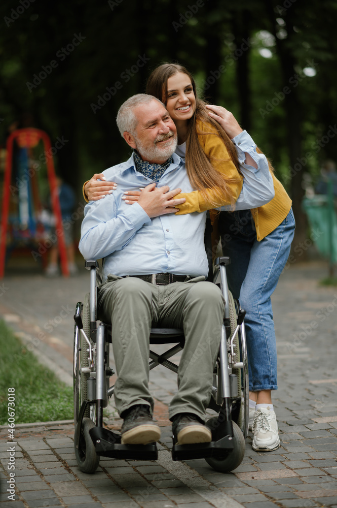 Fototapeta premium Daughter and disabled father, family in park