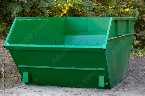 empty large green metal container for construction or other bulky garbage photo